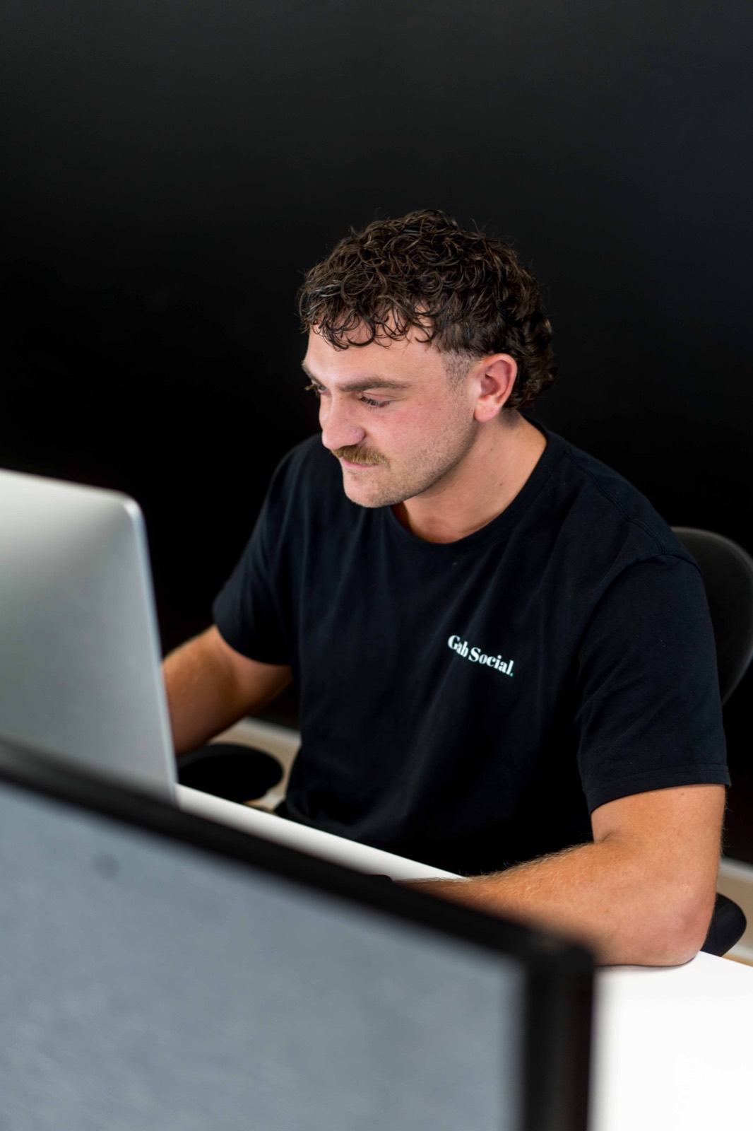 A Grab Social team member managing ad campaigns at his desk