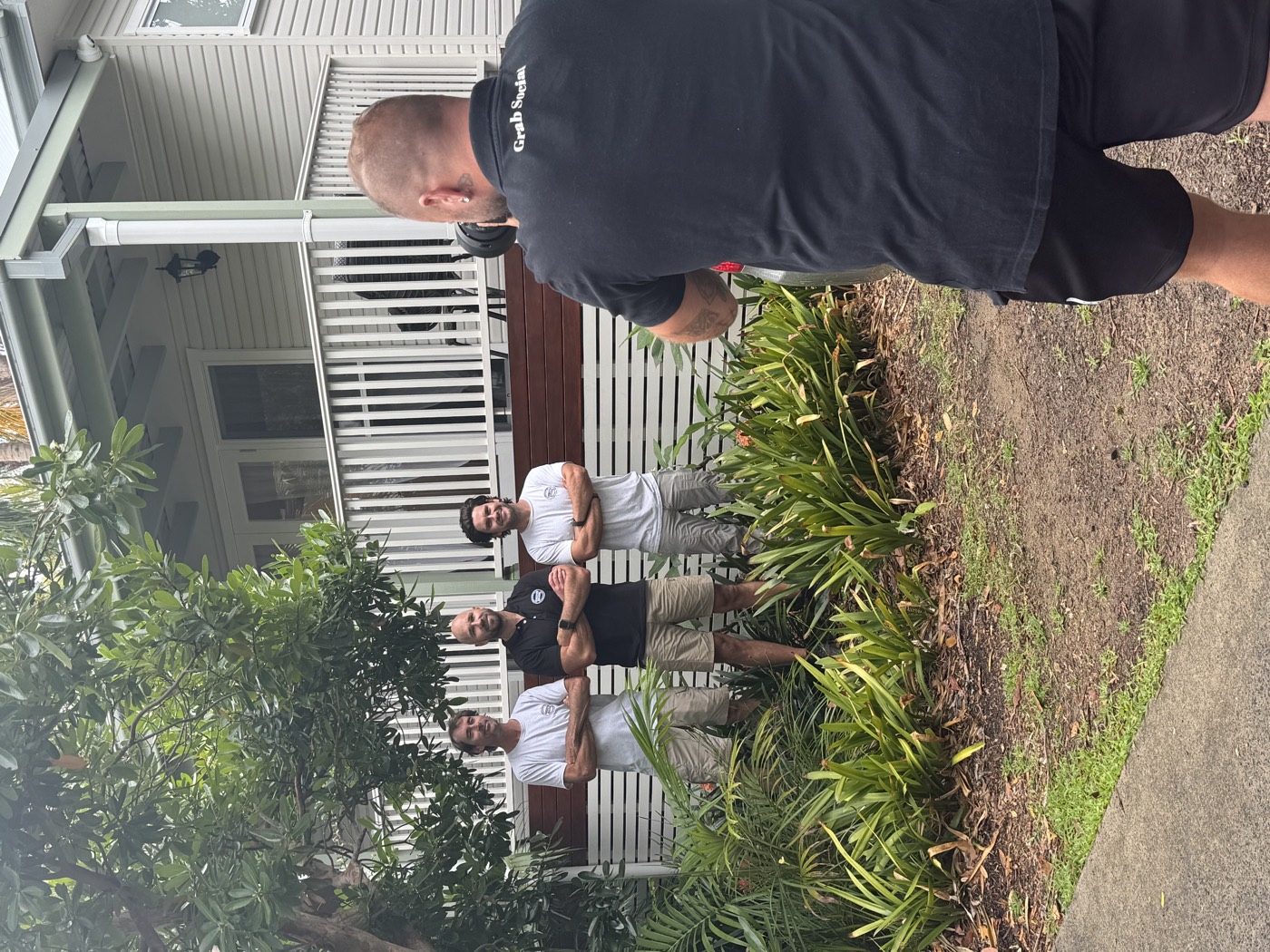 Grab Social photographing a building team outside a home