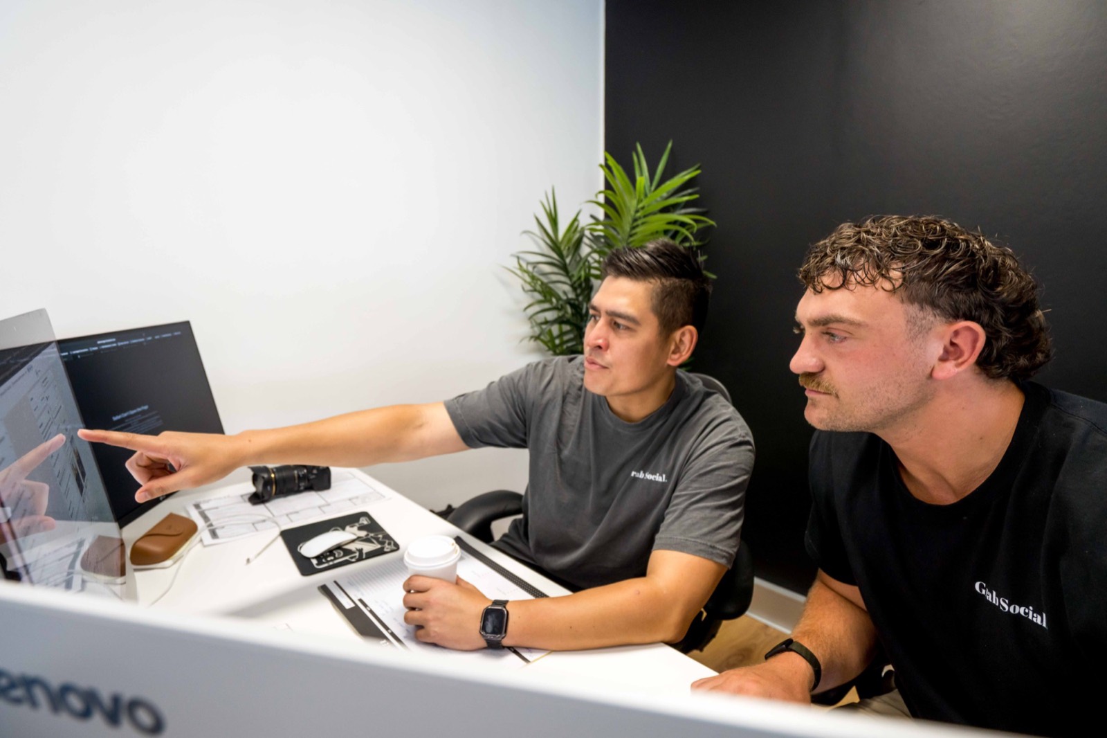 Two Grab Social team members reviewing a campaign on screen