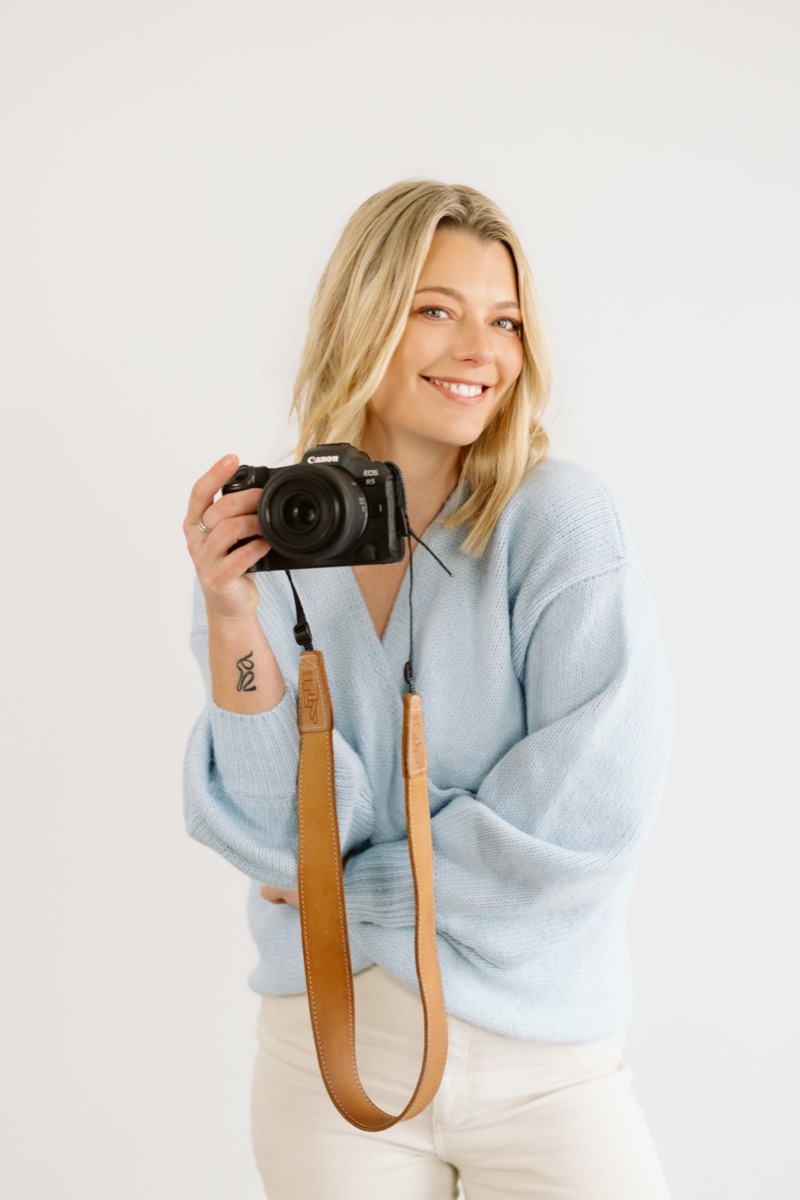 Natalie Alder, photographer, holding her camera