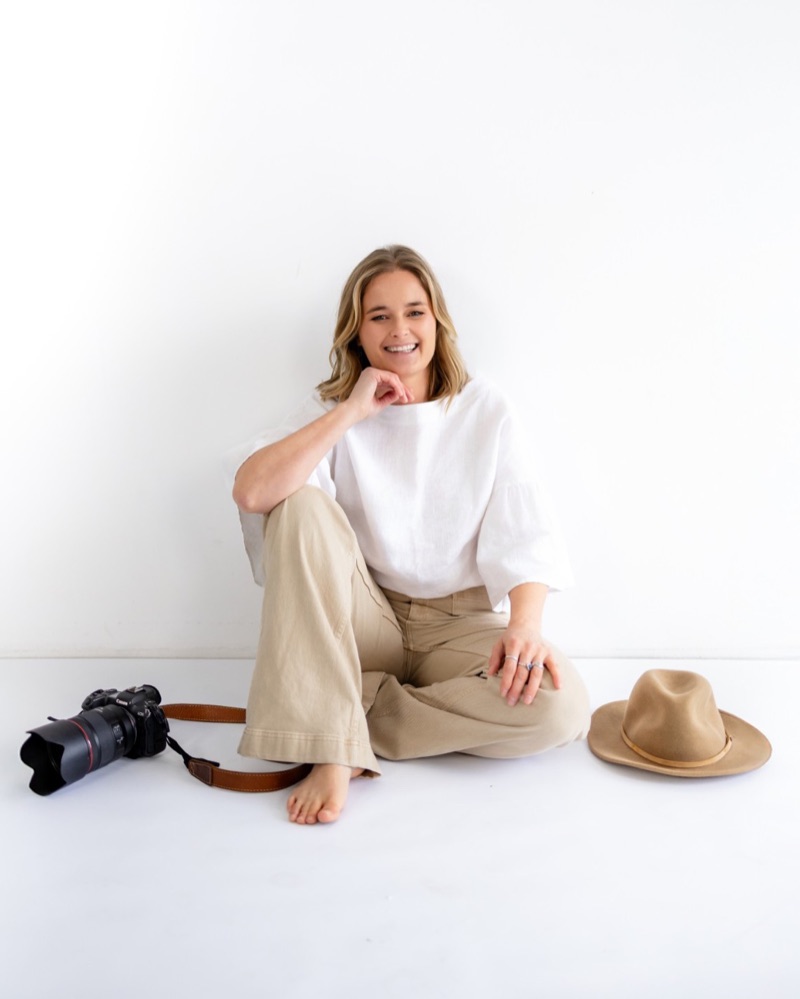 Tasha Van Biene, photographer, sitting in Grab Studio with her camera