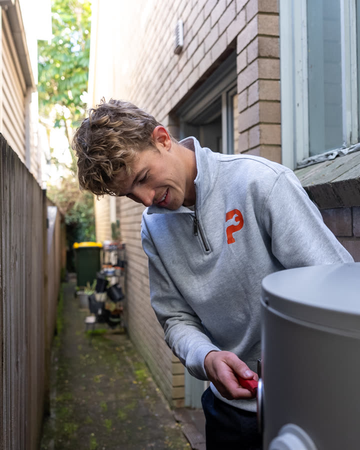 Plumber servicing a hot water system